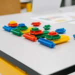 Colorful interlocking building blocks arranged on a table during a lean games workshop.