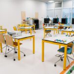 classroom setup with interactive workstations and materials prepared for a lean manufacturing game