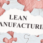 Torn paper revealing the phrase "Lean Manufacturing" surrounded by puzzle pieces, symbolizing the concept of 5S lean production.
