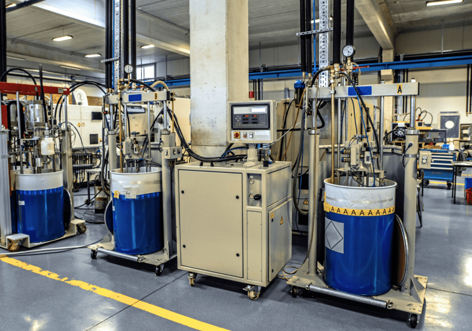 Row of medium-size resin-dispensing stations in a clean, well-lit factory cell.
