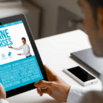 Professional viewing an online courses portal on a tablet for lean training manufacturing.