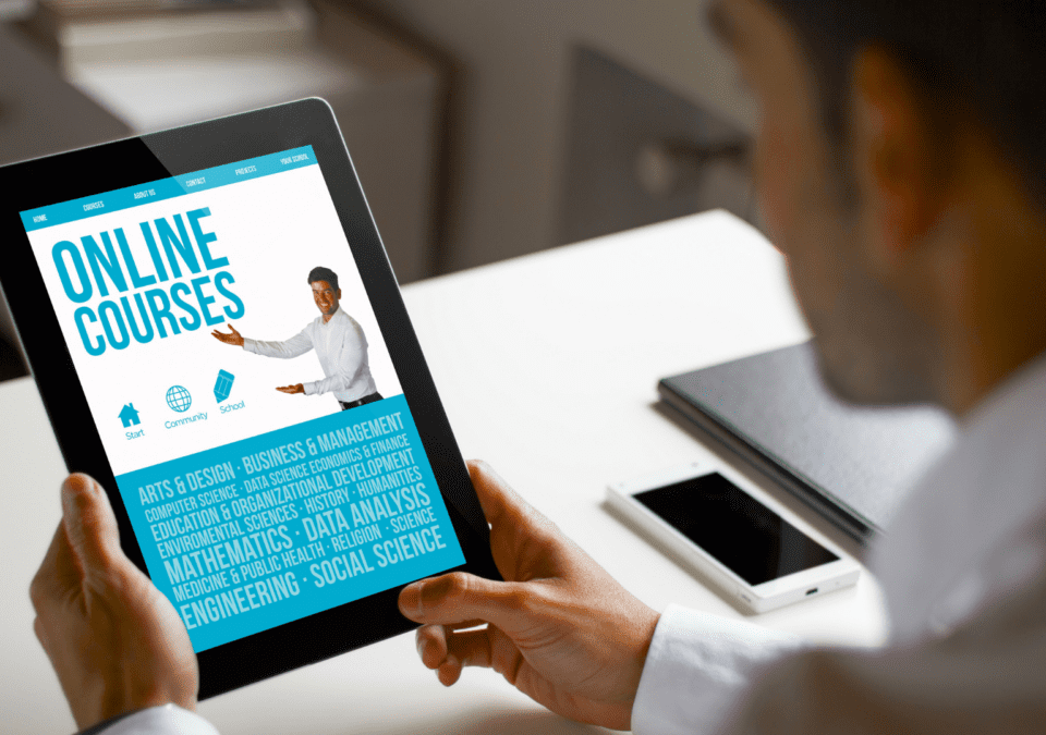 Professional viewing an online courses portal on a tablet for lean training manufacturing.