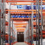 Warehouse shelves filled with inventory illustrating storage waste from the wastes of Lean