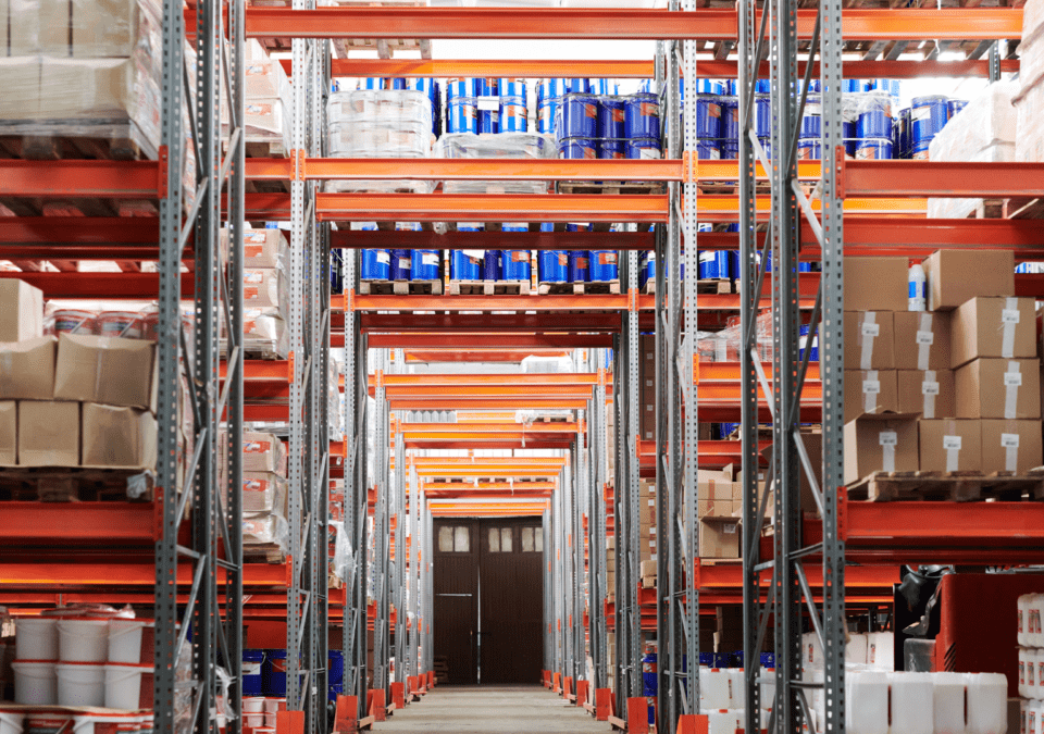 Warehouse shelves filled with inventory illustrating storage waste from the wastes of Lean