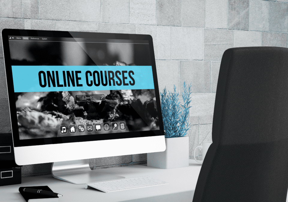 Desktop computer displaying an ‘ONLINE COURSES’ portal for lean training courses in a modern office setting.”