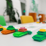 Top-down view of a training table set up for Effective Lean Games with instructions and modular builds.