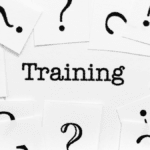 Word ‘Training’ surrounded by black question marks on white cards, symbolizing the search for Lean Manufacturing Certification knowledge.”