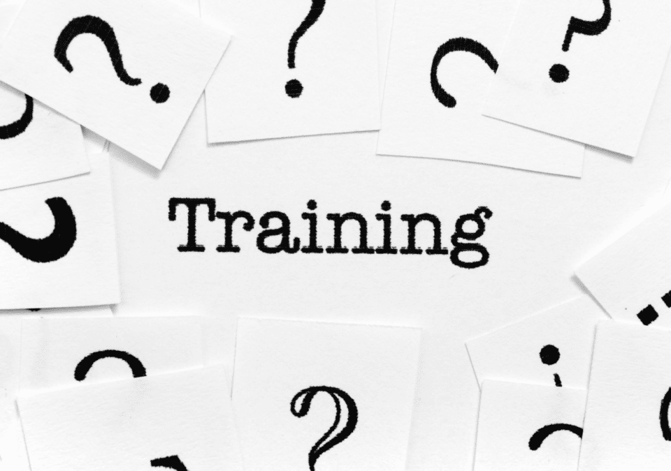 Word ‘Training’ surrounded by black question marks on white cards, symbolizing the search for Lean Manufacturing Certification knowledge.”