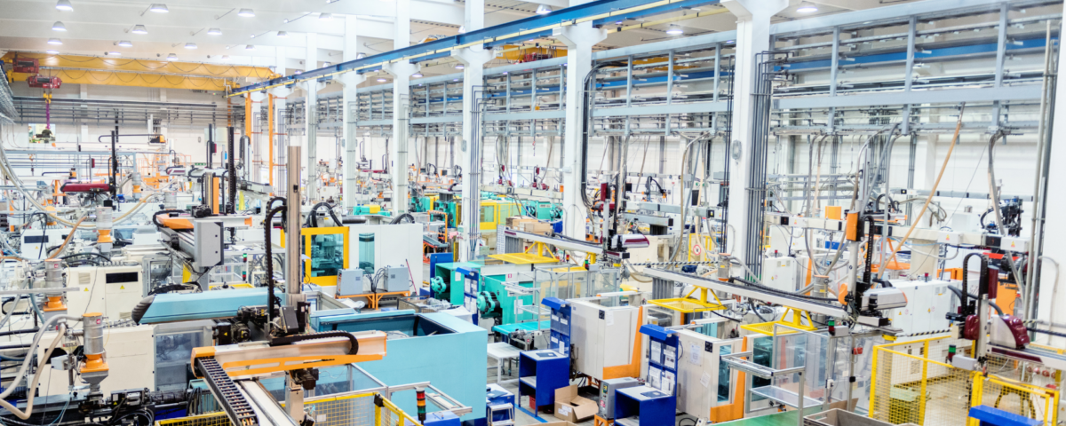 busy manufacturing floor with machinery and staff working in harmony after teamwork training