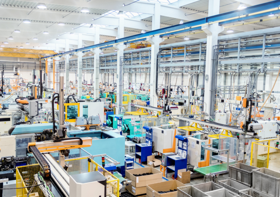 busy manufacturing floor with machinery and staff working in harmony after teamwork training