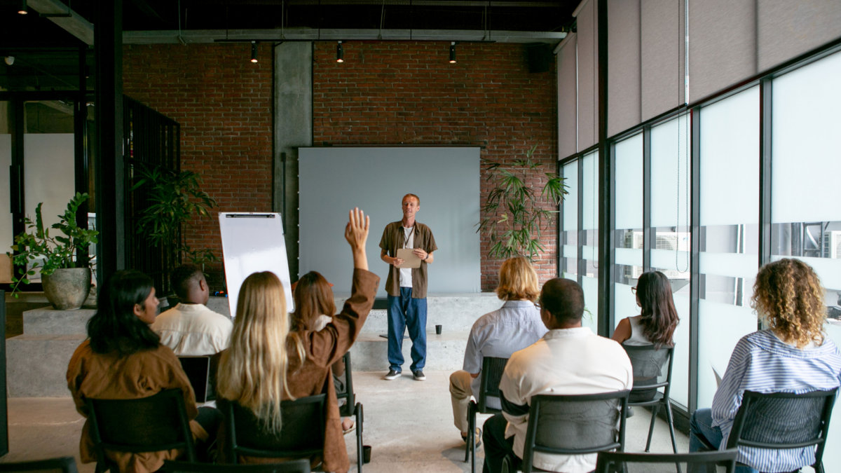 A facilitator conducting an interactive teamwork trainings session for a group of professionals.