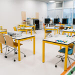 classroom setup with interactive workstations and materials prepared for a lean manufacturing game