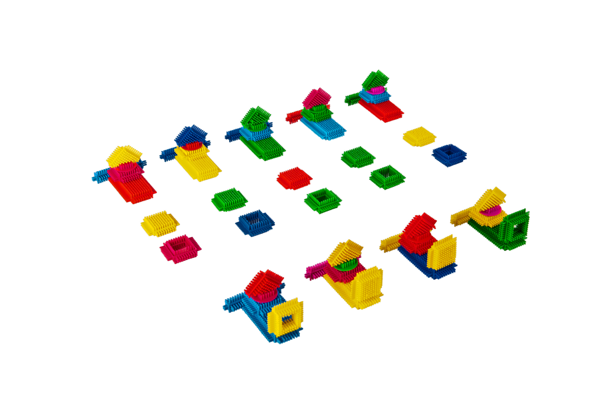 Colourful interlocking bricks neatly staged as a parts kit for a lean simulation exercise.	