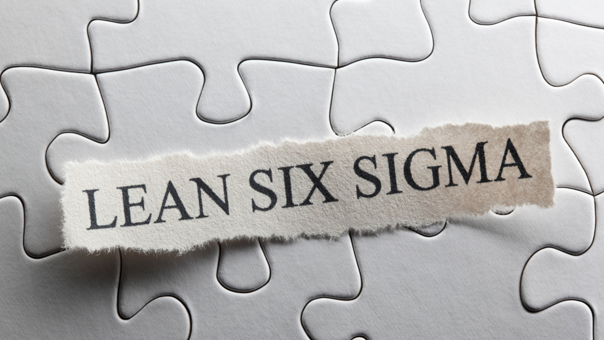 Puzzle background with a ripped paper strip labeled "Lean Six Sigma" – representing continuous improvement strategies such as Lean 5S and Six Sigma.