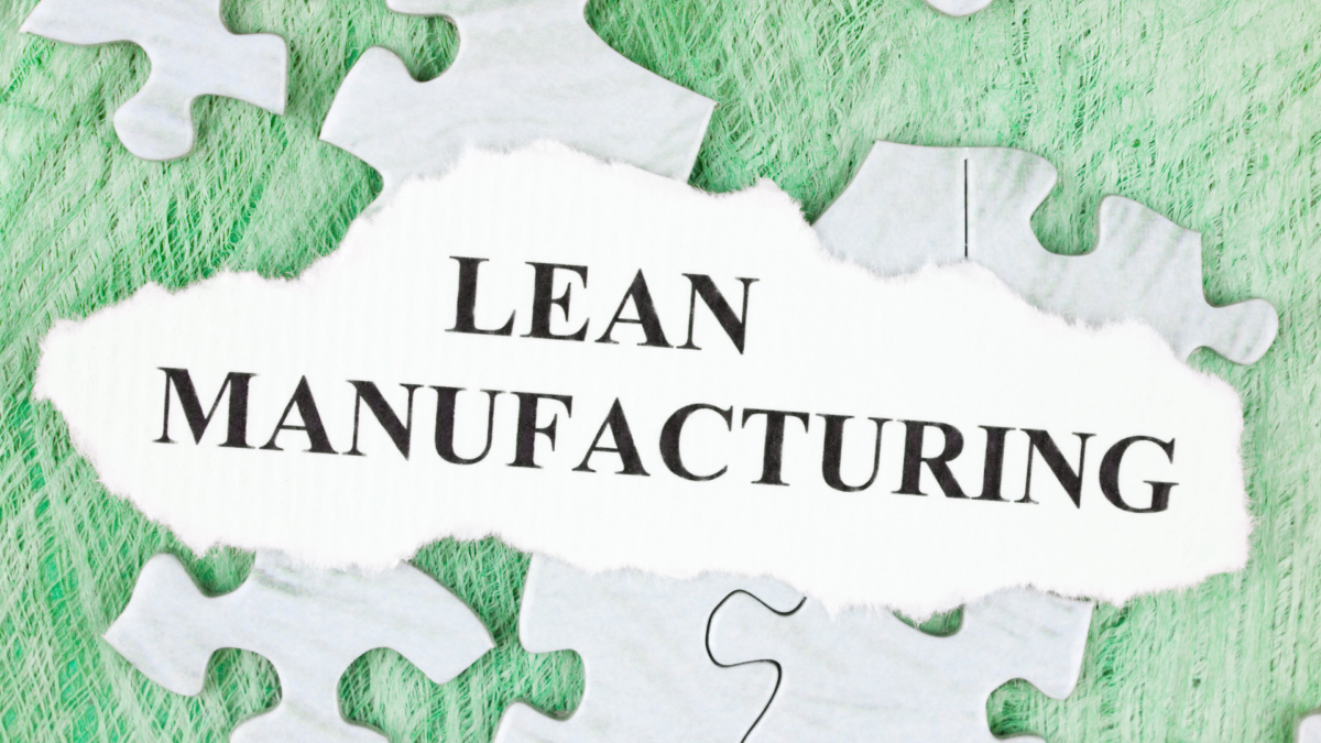 Lean Manufacturing concept on torn paper surrounded by puzzle pieces, symbolizing systematic approaches like 5S Checklists.