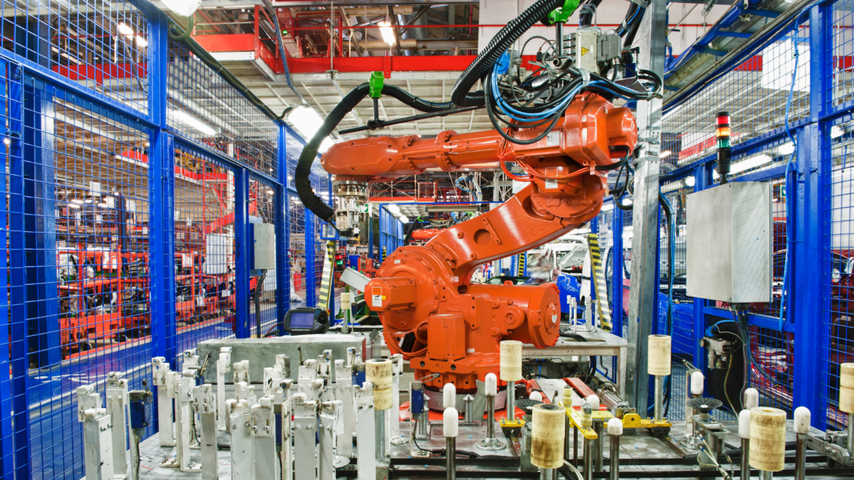 Industrial robotic arm in a modern factory, symbolizing automation and the meaning of 5S workplace efficiency principles. 