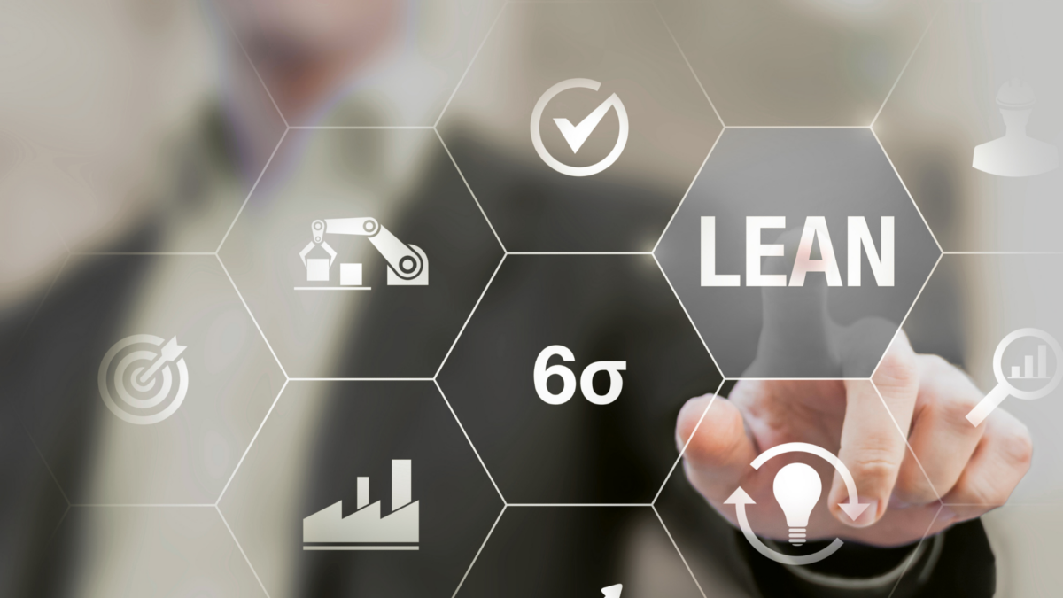 Businessperson activating digital Lean and Six Sigma icons representing 5S methodology implementation in modern manufacturing.