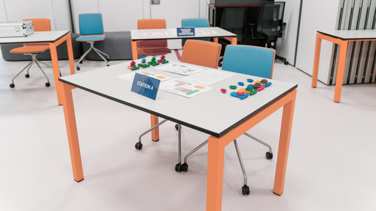 Lean training station setup with colorful elements and visual instructions for Training Lean Management. 