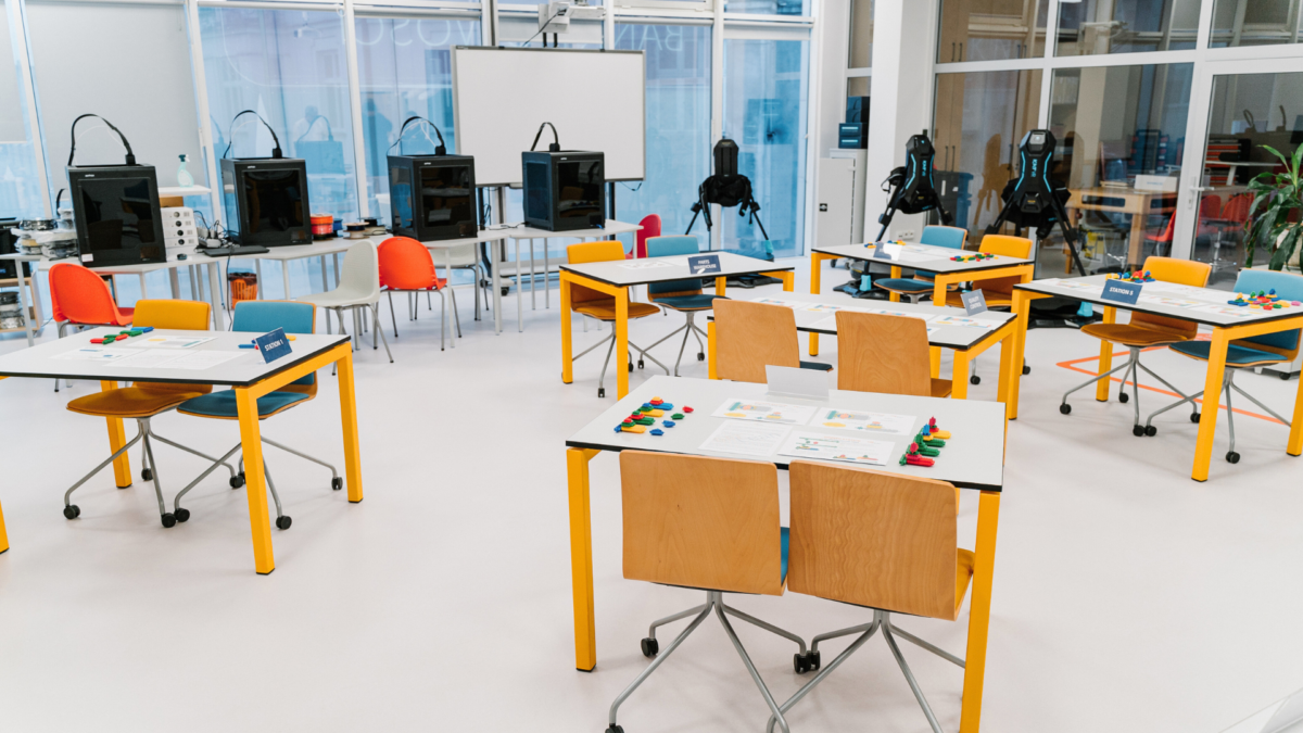Classroom setup prepared for Lean Management Simulation Games with labeled stations and training materials. 