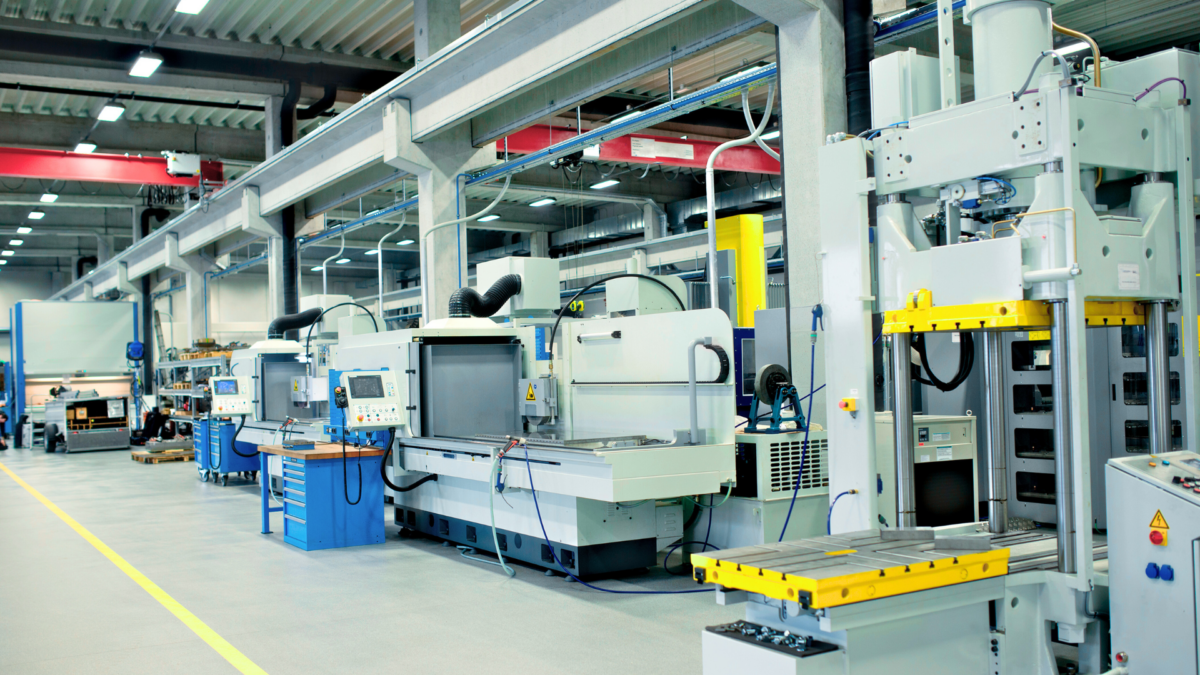 Bright, well-organized factory hall used for a lean training program. 