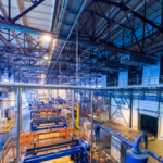 Lean manufacturing explained through real factory layout with machinery and flow lines.