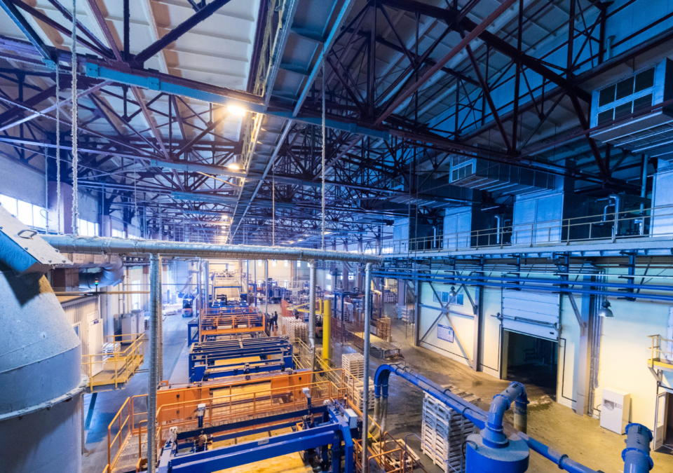 Lean manufacturing explained through real factory layout with machinery and flow lines.