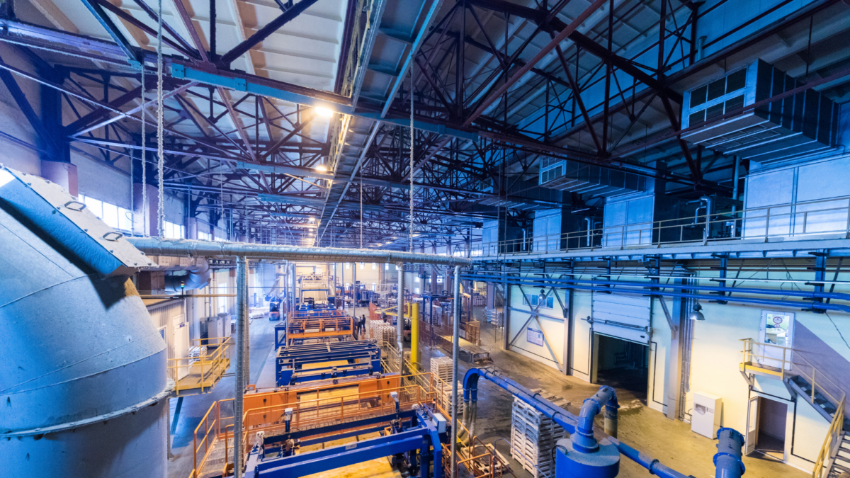 Lean manufacturing explained through real factory layout with machinery and flow lines.