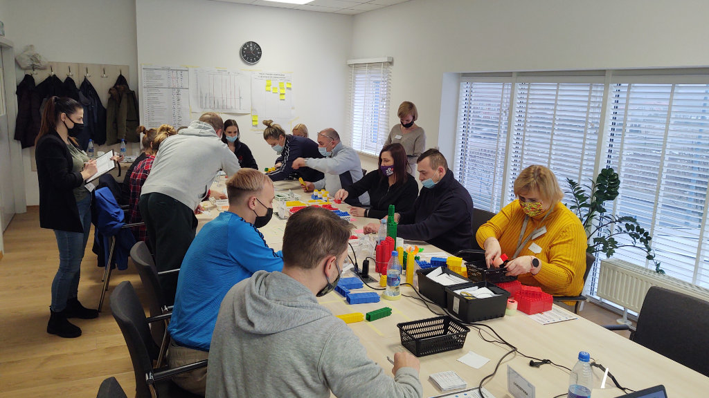 Team participating in a lean management games using blocks and simulations during a training workshop. 